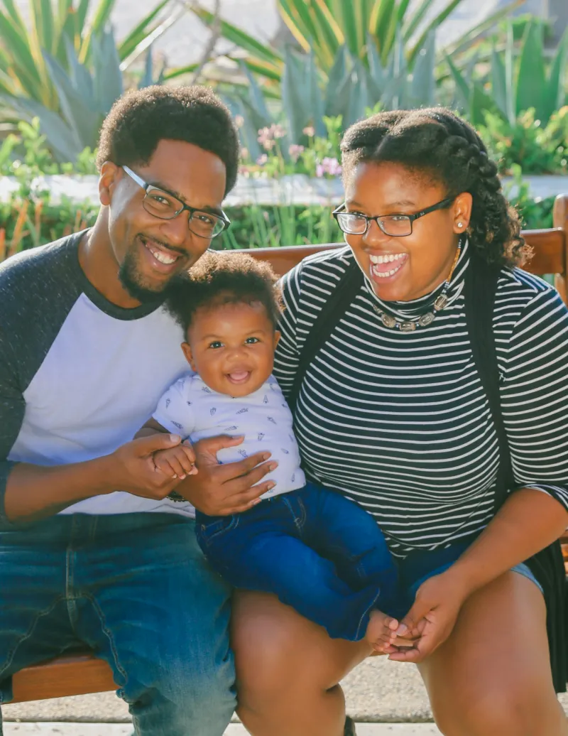 Parents laughing together with their baby